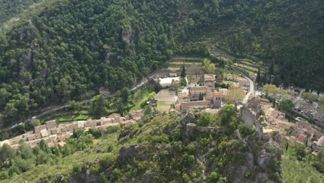 Aerial-drone-view-flying-around-castle-ruins-with-Saint-Guilhem-le-Desert